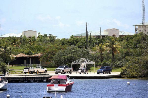 Vehicles are parked on a government dock in Red Hook where FBI agents were seen last Monday boarding a boat, in St. Thomas, U.S. Virgin Islands on Aug. 14, 2019. (Gabriel Lopez Albarran/AP Photo)