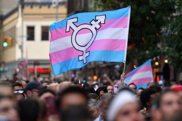 A transgender pride flag is held aloft in New York on June 28, 2019. (Angela Weiss/AFP/Getty Images)