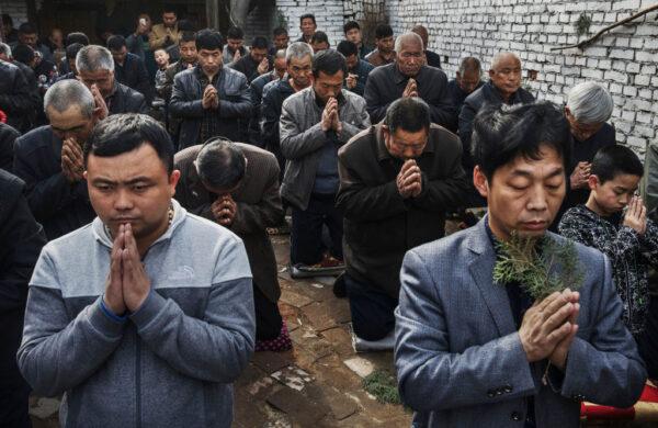 Chinese Catholic worshippers kneel and pray during Palm Sunday Mass during the Easter Holy Week at an "underground" or "unofficial" church on April 9, 2017 near Shijiazhuang, Hebei Province, China on April 9, 2017. (Kevin Frayer/Getty Images)
