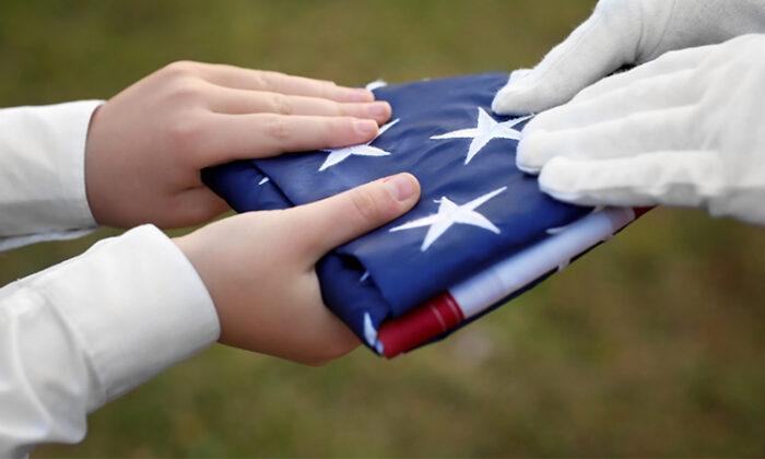 Boy Uses His Body As a Shield When Friends Struggle to Fold American Flag on Windy Day