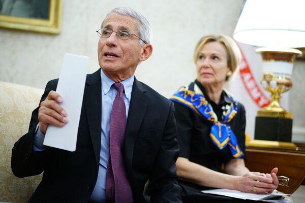 Dr. Anthony Fauci, left, director of the National Institute of Allergy and Infectious Diseases speaks next to response coordinator for White House Coronavirus Task Force Dr. Deborah Birx, during a meeting in the Oval Office of the White House in Washington on April 29, 2020. (Mandel Ngan/AFP via Getty Images)