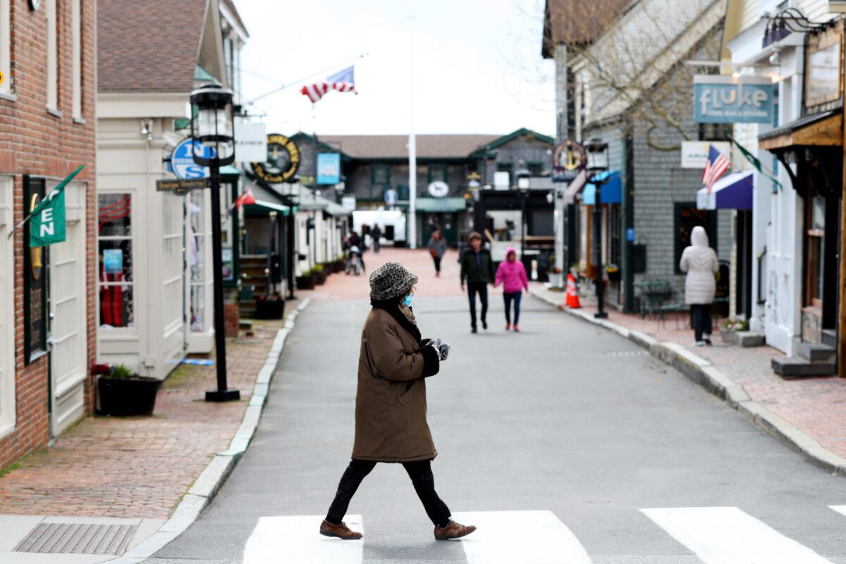 A pedestrian walks past Bannister's Wharf in Newport, R.I., as so-called non-essential retailers reopened, on May 9, 2020. (Maddie Meyer/Getty Images)