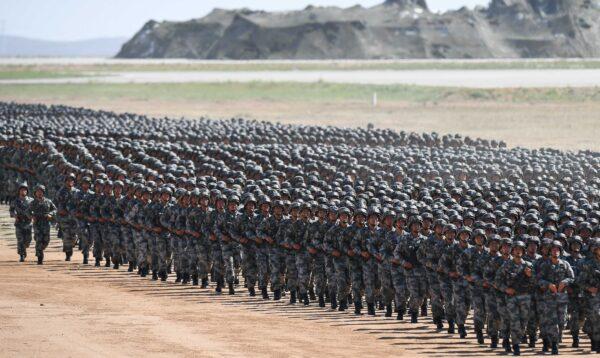Chinese soldiers march in a military parade at the Zhurihe training base in China's northern Inner Mongolia region on July 30, 2017. (STR/AFP via Getty Image)