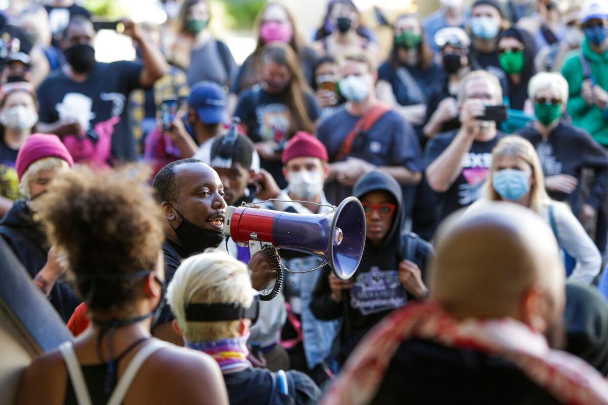 Mark Henry Jr. of Black Lives Matter addresses a crowd in an area being called the Capitol Hill Autonomous Zone in Seattle, Wash., on June 11, 2020. (Jason Redmond/AFP via Getty Images)