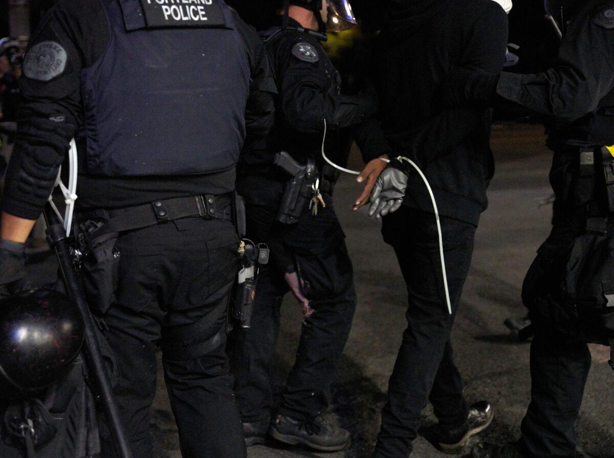 Oregon State Police arrest a person during rioting Portland, Ore., on Sept. 4, 2020. (Nathan Howard/Getty Images)