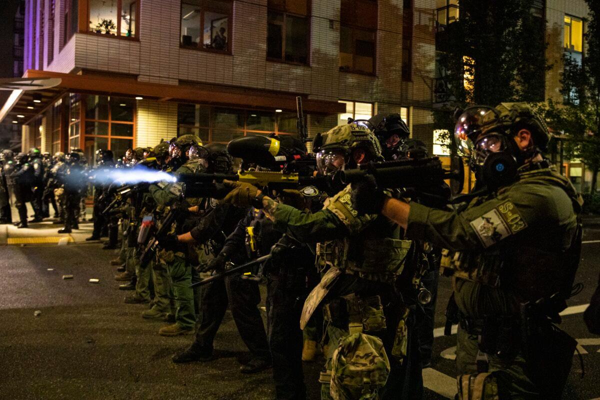 Federal officers face off with a crowd in Portland, Ore., Sept. 18, 2020. (Paula Bronstein/AP Photo)