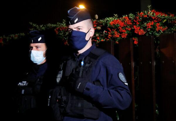Police officers secure the area near the scene of a stabbing attack in the Paris suburb of Conflans St Honorine, France, Oct. 16, 2020. (Charles Platiau/Reuters)