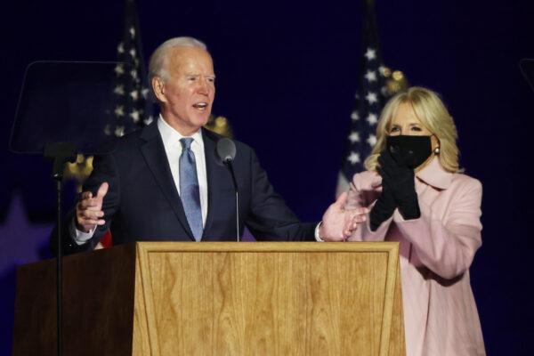 Democratic presidential nominee Joe Biden speaks at a drive-in election night event as Dr. Jill Biden looks on at the Chase Center in Wilmington, Delaware, in the early morning hours of Nov. 4, 2020. (Win McNamee/Getty Images)