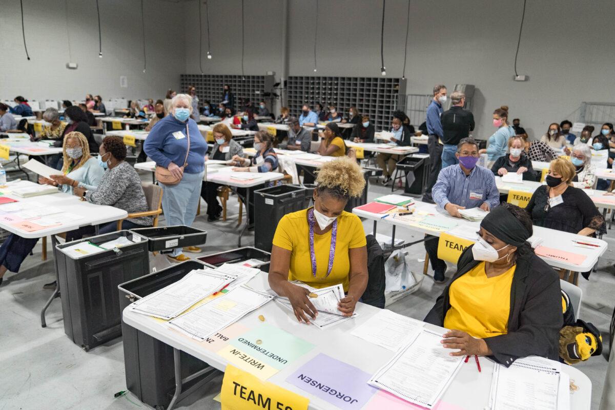 Gwinnett County election workers handle ballots as part of the recount for the 2020 presidential election at the Beauty P. Baldwin Voter Registrations and Elections Building in Lawrenceville, Ga., on Nov. 16, 2020. (Megan Varner/Getty Images)