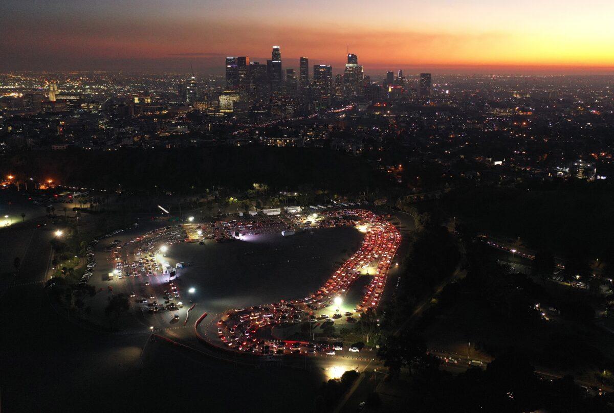 Cars are lined up at Dodger Stadium for COVID-19 testing as dusk falls over downtown Los Angeles, Calif., on Dec. 2, 2020. (Mario Tama/Getty Images)