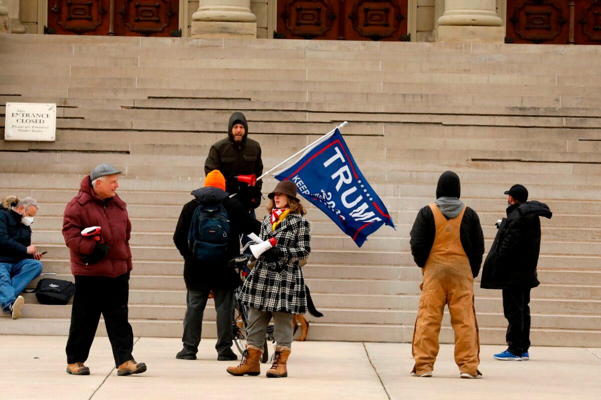 Supporters of President Donald Trump gather on the steps of the Michigan state capital as the Electoral College votes, in Lansing, Mich., on Dec. 14, 2020. (Jeff Kowalsky/AFP via Getty Images)