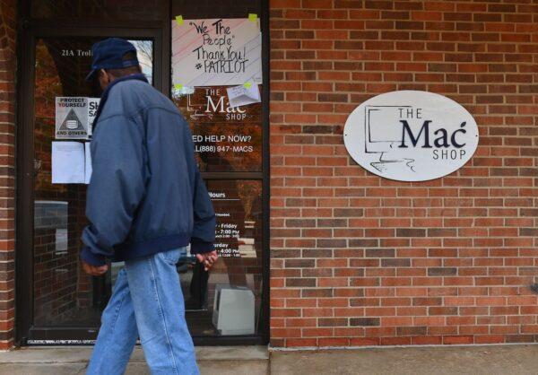 A man walks past "The Mac Shop" in Wilmington, Del., on Oct. 21, 2020. (Angela Weiss/AFP via Getty Images)