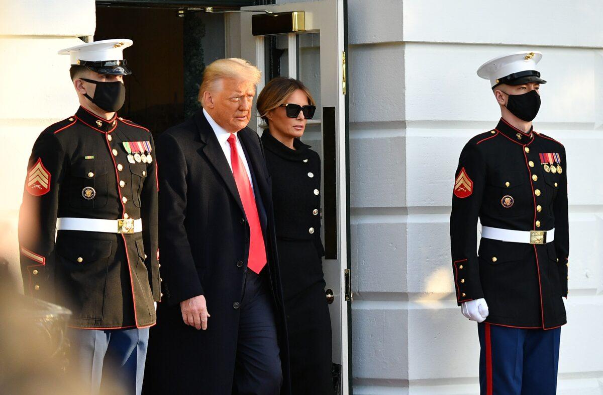 Then-President Donald Trump and First Lady Melania make their way to board Marine One before departing from the South Lawn of the White House in Washington on Jan. 20, 2021. (Mandel Ngan/AFP via Getty Images)