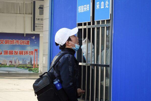 A man gets a nasal swab for the COVID-19 test at a testing site outside Yichangdong Railway Station in Yichang, central China's Hubei Province on Jan. 28, 2021. (STR/AFP via Getty Images)