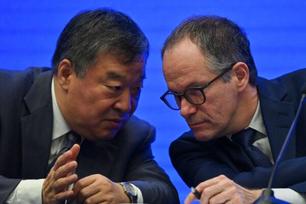 Peter Ben Embarek (R) talks with Liang Wannian (L) during a press conference in the city of Wuhan, in China's Hubei province on February 9, 2021. (HECTOR RETAMAL/AFP via Getty Images)