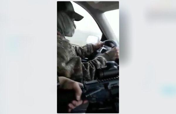 A screenshot of a video shows a suspected smuggler and passenger carrying a high-powered rifle as they transport illegal aliens on private land in Texas. (Courtesy of Susan Kibbe)