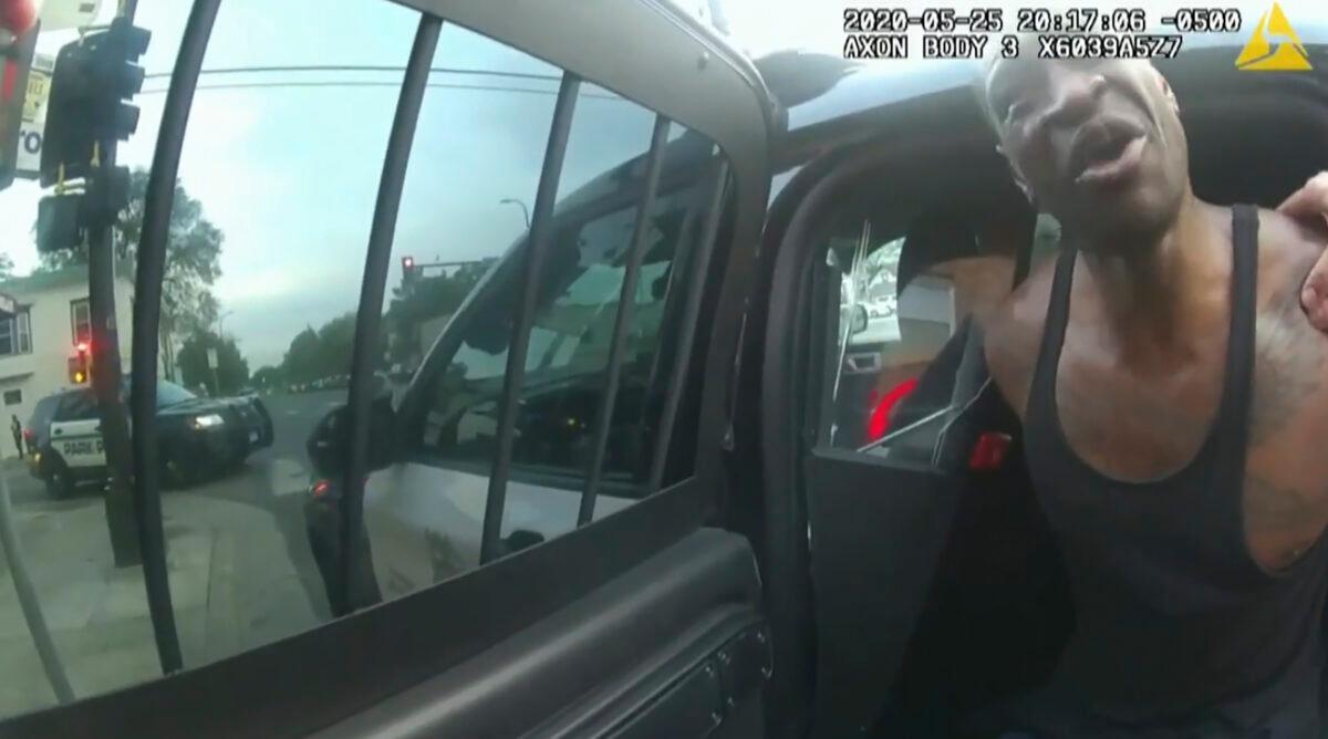 In this image from police body camera footage, Minneapolis police officers attempt to place George Floyd in a police vehicle, on May 25, 2020, outside Cup Foods in Minneapolis, as is shown in the trial of former Minneapolis police Officer Derek Chauvin in the death of Floyd, at the Hennepin County Courthouse in Minneapolis, on March 31, 2021. (Court TV via AP/Pool)
