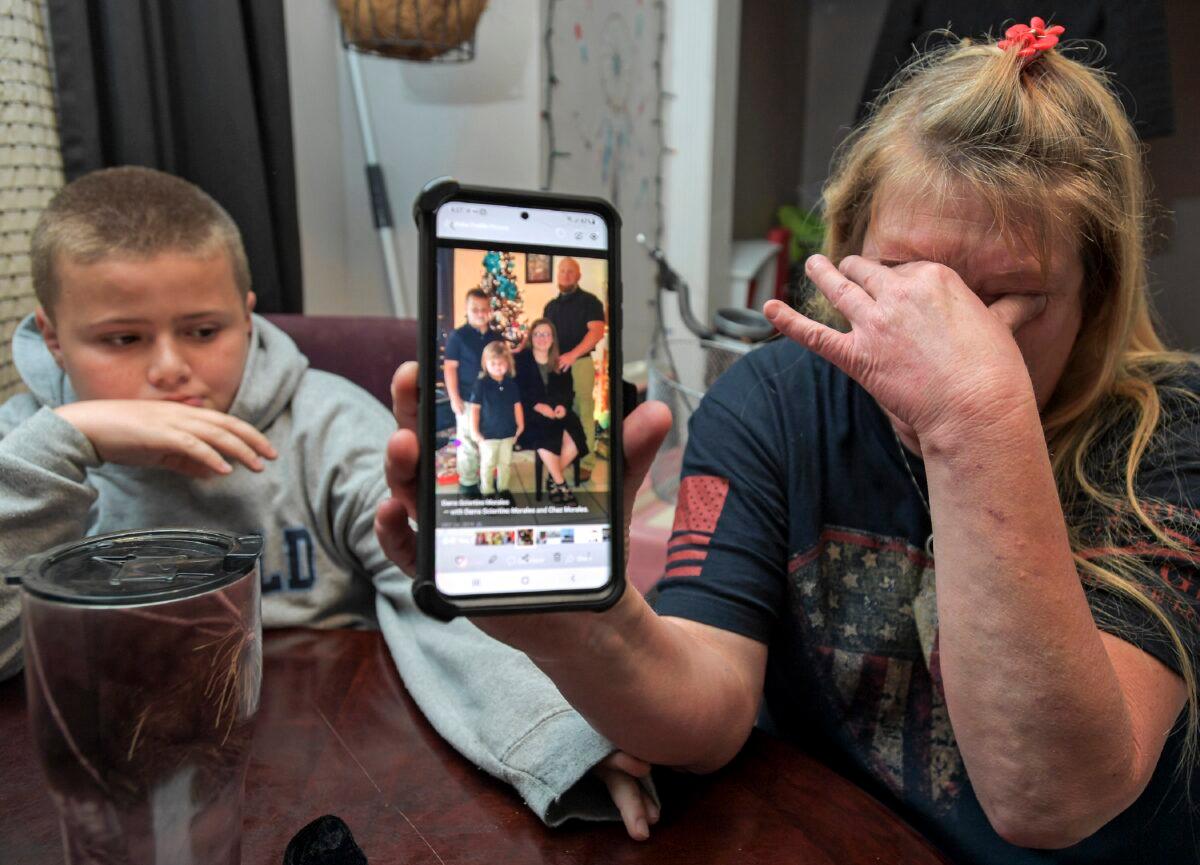 Darra Ann Morales, right, shows a photo of her son Chaz Morales and his family on her phone, as Chaz Jr., 10, comforts his grandmother at their home in Slidell, La., on April 14, 2021. (Max Becherer/The Times-Picayune/The New Orleans Advocate via AP)