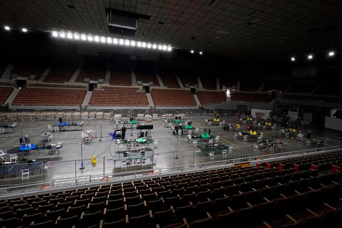 Ballot scanning equipment is set up by Cyber Ninjas, a Florida-based consultancy, overseeing an audit at the Arizona Veterans Memorial Coliseum in Phoenix, on April 22, 2021. (Ross D. Franklin/AP Photo)