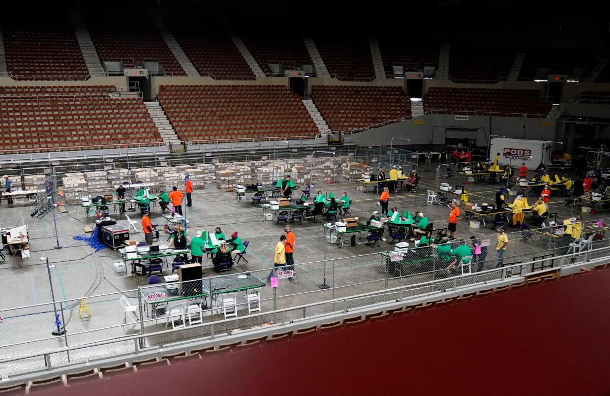A general view of Veterans Memorial Coliseum shows ballots being reviewed during an audit of the 2020 election, in Phoenix, on April 29, 2021. (Rob Schumacher/The Arizona Republic via AP/Pool)