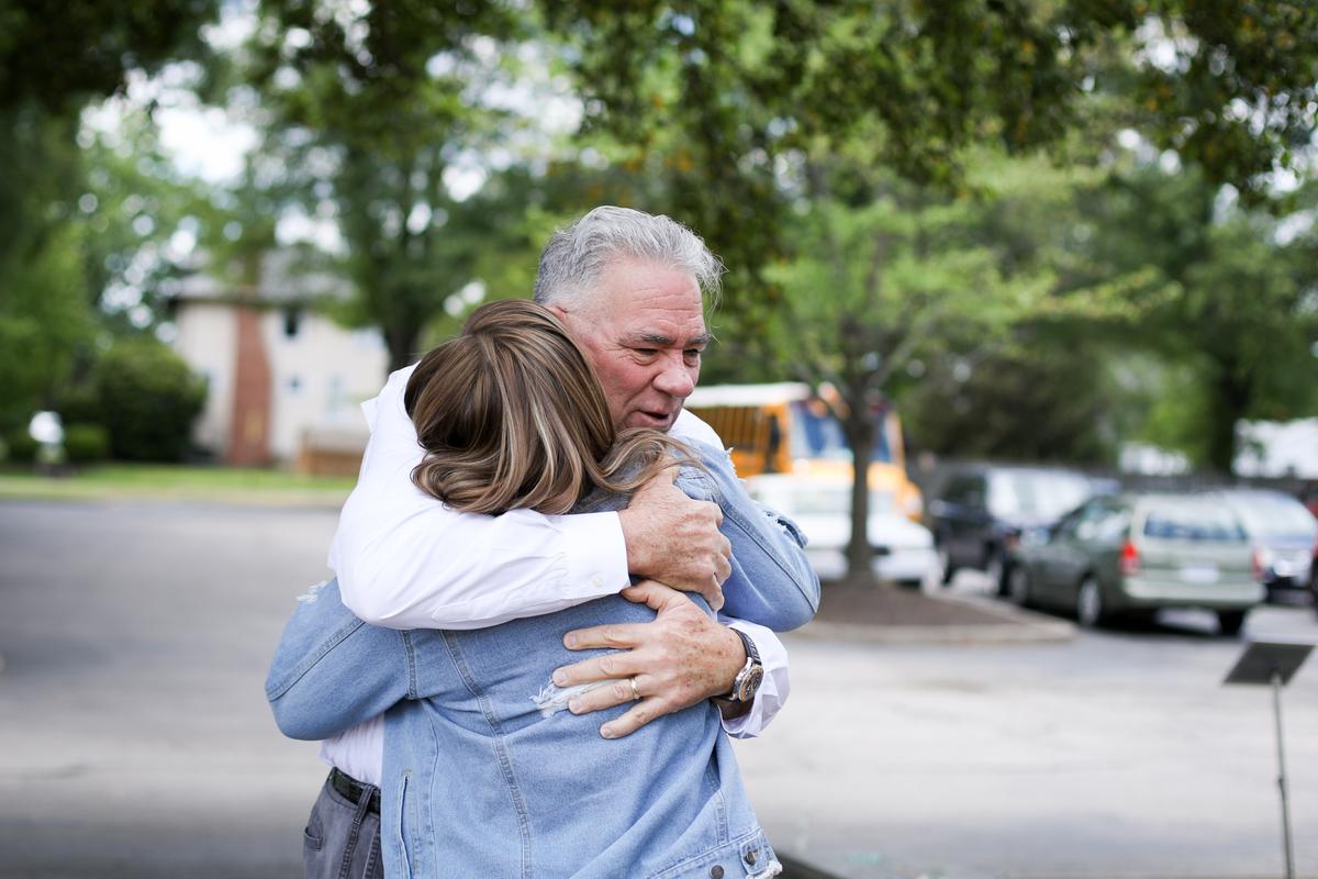 John Shinholser, president and co-founder of The McShin Foundation, a nonprofit recovery community organization, hugs a woman in Richmond, Va., on May 13, 2021. (Samira Bouaou/The Epoch Times)
