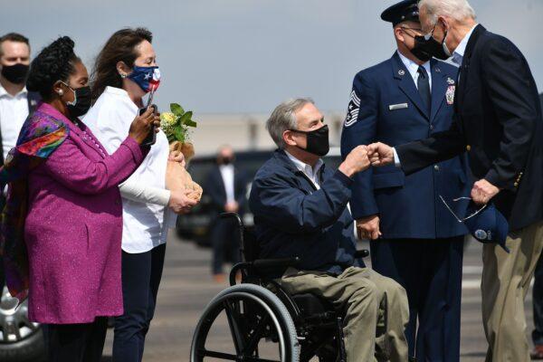 President Joe Biden (R) greets Texas Gov. Greg Abbott and his wife Cecilia Abbott (2nd L) at Ellington Field Joint Reserve Base in Houston, on Feb. 26, 2021. (Mandel Ngan/AFP via Getty Images)