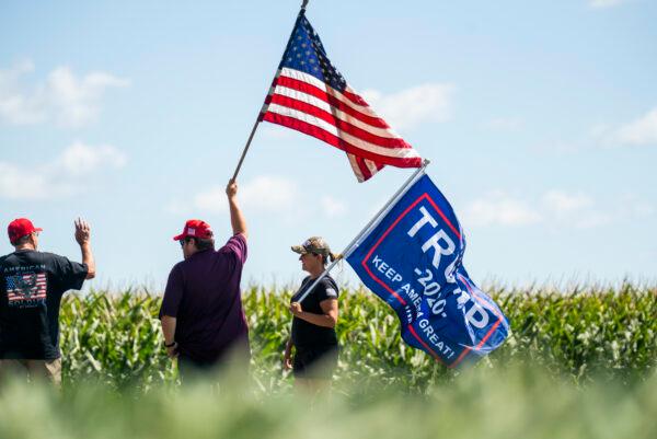 Supporters wave flags outside of Mankato Regional Airport as President Donald Trump makes a campaign stop in Mankato, Minn., on Aug. 17, 2020. (Stephen Maturen/Getty Images)