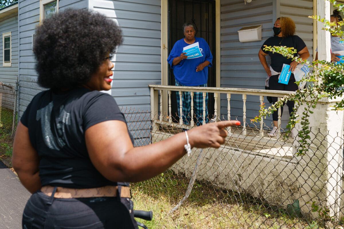 Jefferson County Commissioner Sheila Tyson (L) accompanies volunteers and staffers during a door-knocking outreach effort to inform residents about an upcoming COVID-19 vaccination event in Birmingham, Ala., on June 30, 2021. (Elijah Nouvelage/AFP via Getty Images)
