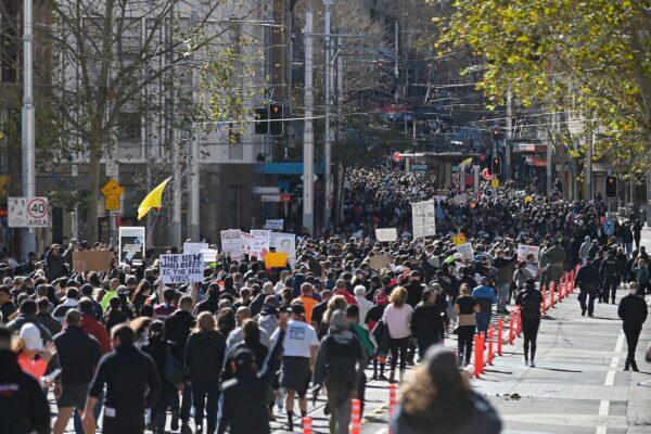 Thousands of protesters march on the streets of the central business district of Sydney, on July 24, 2021. (Steven Saphore/AFP via Getty Images)
