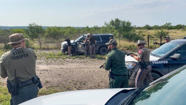 Texas, Nebraska, and Iowa State Troopers prepare to search a stolen vehicle in Kinney County, Texas, on July 21, 2021. (Charlotte Cuthbertson/The Epoch Times)