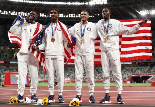 Gold medal winners Bryce Deadmon, Michael Cherry, Michael Norman, and Rai Benjamin of Team USA celebrate with their medals after the Men's 4x400m Relay on day 15 of the Tokyo 2020 Olympic Games at Olympic Stadium in Tokyo on Aug. 7, 2021. (Ryan Pierse/Getty Images)