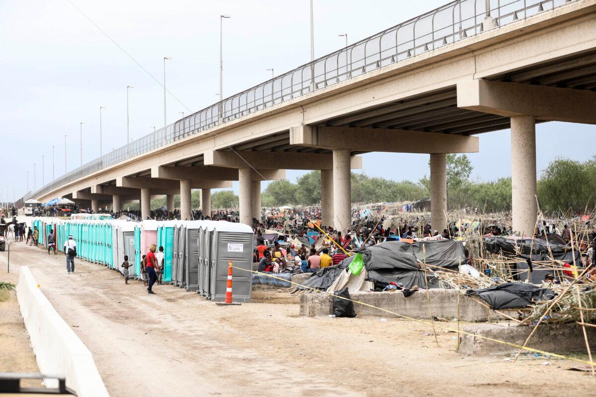 Thousands of illegal immigrants, mostly Haitians, live in a primitive, makeshift camp under the International Bridge, which spans the Rio Grande between the United States and Mexico, while waiting to be detained and processed by Border Patrol, in Del Rio, Texas, on Sept. 21, 2021. (Charlotte Cuthbertson/The Epoch Times)