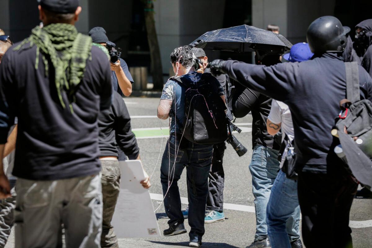 Andy Ngo, a Portland-based journalist, is seen covered in an unknown substance after unidentified Rose City Antifa members attacked him in Portland, Ore., on June 29, 2019. (Moriah Ratner/Getty Images)