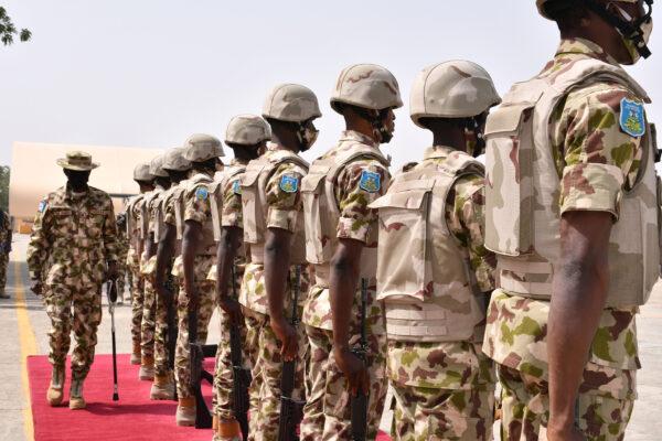 Chief of defense staff Maj. Gen. Leo Irabor (L) inspects soldiers standing at attention during a guard of honor in Maiduguri, Nigeria, on Jan. 31, 2021. (Audu Marte/AFP via Getty Images)