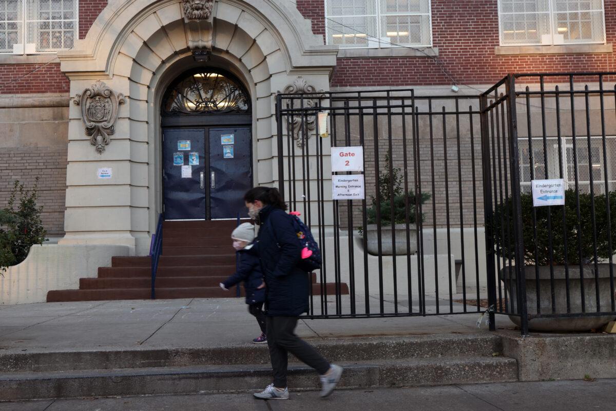 People walk by a public school in Brooklyn, New York City, on Nov. 18, 2020. (Spencer Platt/Getty Images)