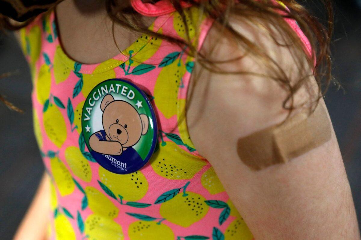 A child wears a pin she received after receiving her first dose of the Pfizer COVID-19 vaccine at the Beaumont Health offices in Southfield, Michigan, on Nov. 5, 2021. (Jeff Kowalsky/AFP via Getty Images)