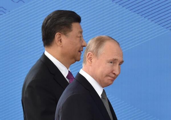 Russian President Vladimir Putin and Chinese leader Xi Jinping walk as they attend a meeting of the Shanghai Cooperation Organisation Council of Heads of State in Bishkek, Kyrgyzstan, on June 14, 2019. (Vyacheslav Oseledko/AFP via Getty Images)