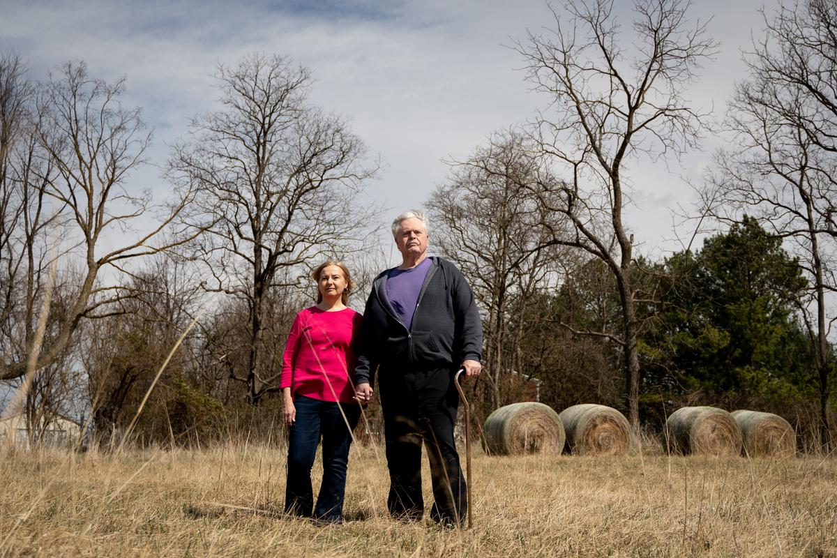 Thomas and Sharon Caldwell on their farm, now empty after they sold their animals and equipment to pay legal bills, in Berryville, Va., on March 19, 2022. (Samira Bouaou/The Epoch Times)