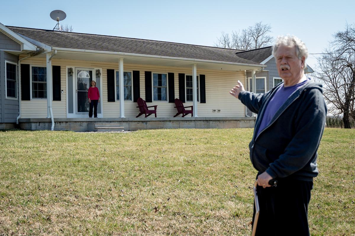 Thomas Caldwell recounts the FBI raid as Sharon stands at the spot where laser dots appeared on her face and chest from the carbine barrels of an FBI SWAT team, at their home in Berryville, Va., on March 19, 2022. (Samira Bouaou/The Epoch Times)