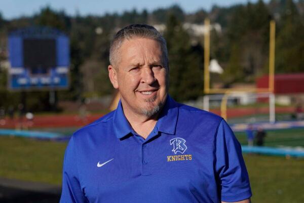 Joe Kennedy, a former assistant football coach at Bremerton High School in Bremerton, Wash., poses for a photo March 9, 2022, at the school's football field. (AP Photo/Ted S. Warren)