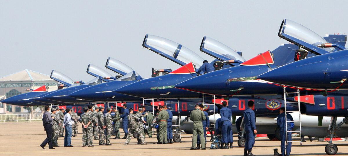 Pilots check a group of seven Chinese-made Jian-10 fighter jets, which will perform aerial stunts at the Air Show in Zhuhai, south China's Guangdong province, on Nov. 8, 2010. (STR/AFP via Getty Images)
