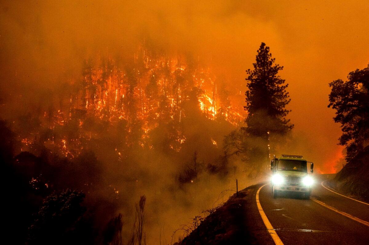 A firetruck drives along California Highway 96 as the McKinney Fire burns in Klamath National Forest, Calif., on July 30, 2022. (Noah Berger/AP Photo)