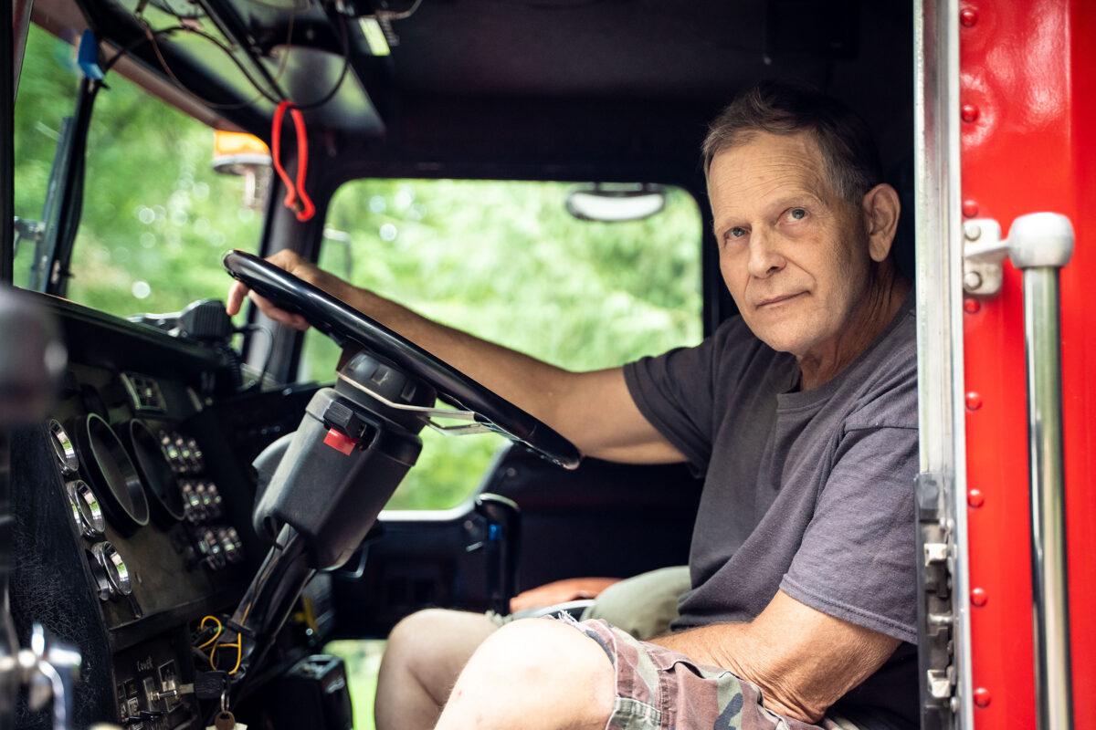 Mark Griffin in the cab of his Kenworth dump truck, at home in Canadensis, Pa., on Aug. 1, 2022. "What he did was wrong," Griffin said of the officer who shot him. (Petr Svab/The Epoch Times)