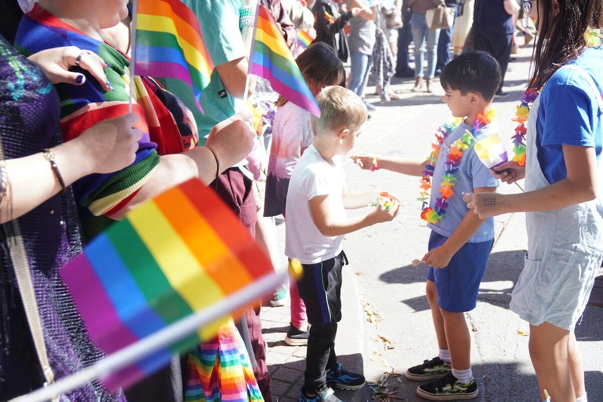Children reach for candy during a Pride parade in Chattanooga, Tennessee on Oct. 2, 2022. (Jackson Elliott/The Epoch Times)