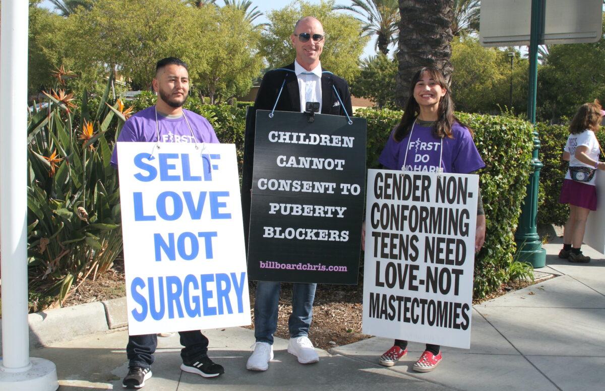 Abel Garcia (L), Billboard Chris (C), and Chloe Cole (R) take part in a demonstration in Anaheim, Calif., on Oct. 8, 2022. (Brad Jones/The Epoch Times)