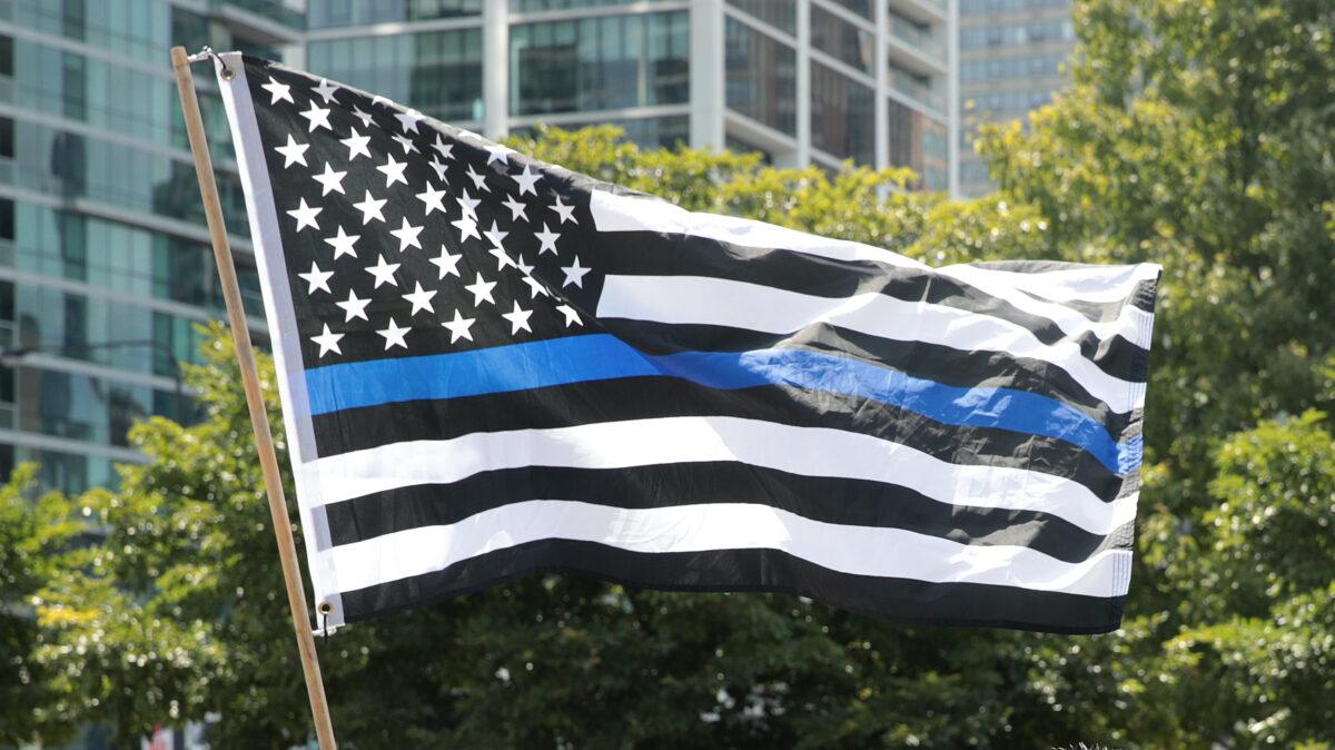 A thin blue line flag flies at a rally in Grant Park in Chicago on July 25, 2020. (Scott Olson/Getty Images)