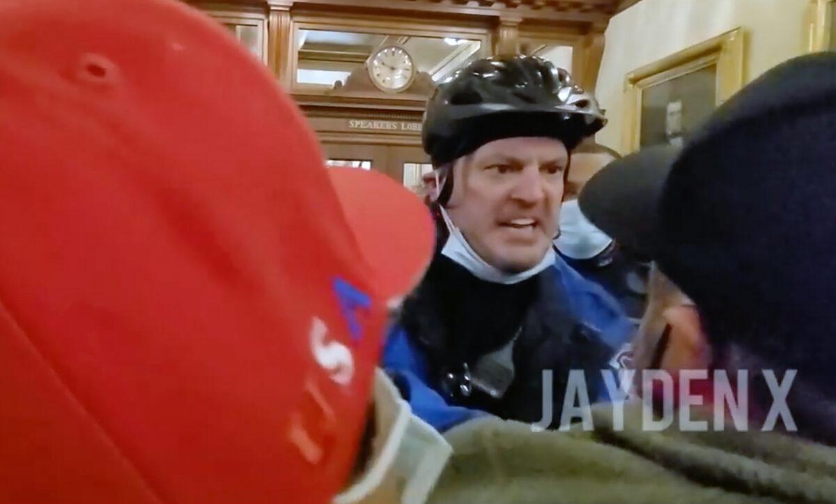 A U.S. Capitol Police officer shoves Dr. Austin Harris down the hallway outside the Speaker's Lobby at the U.S. Capitol on Jan. 6, 2021. (Jayden X/Screenshot via The Epoch Times)