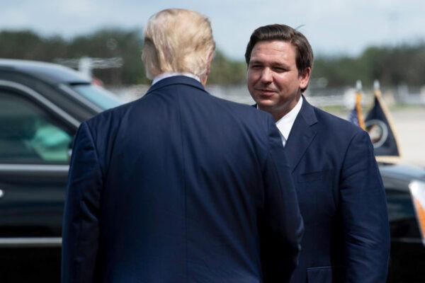 President Donald Trump is greeted by Florida Gov. Ron DeSantis at Southwest Florida International Airport on Oct. 16, 2020. (BRENDAN SMIALOWSKI/AFP via Getty Images)