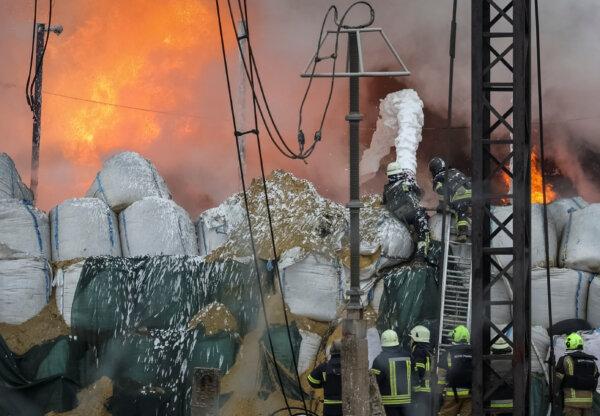 Firefighters work at a site of a power infrastructure object, which was hit during Russia's missile strike outside Kharkiv, Ukraine, on March 22, 2024. (Sofiia Gatilova/Reuters)