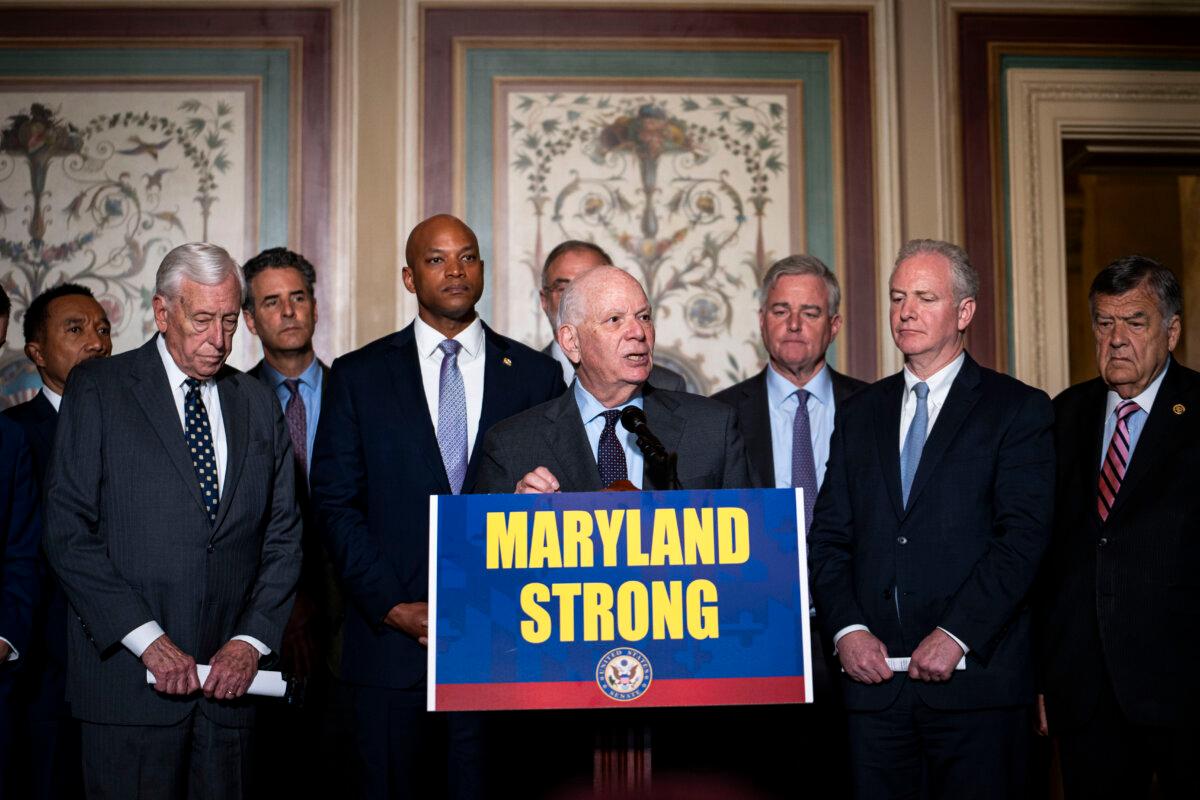 Maryland Gov. Wes Moore (front row, 2nd L) listens while Sen. Ben Cardin (D-Md.) and other lawmakers speak at a press conference in the U.S. Capitol in Washington on April 9, 2024, about rebuilding the Francis Scott Key Bridge, which collapsed after being struck by a cargo ship. (Madalina Vasiliu/The Epoch Times)